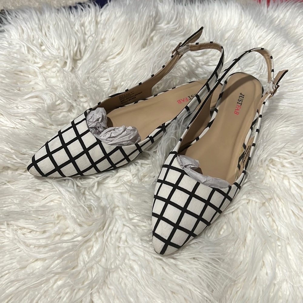 Black and white pointed toe flats with sling back
